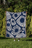 Kio Abstract Print Cotton Throw Blanket in Blue, outdoors