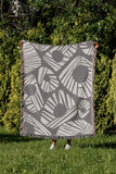 Kio Abstract Print Cotton Throw Blanket in Gray, outdoors