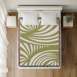 Konga Hand Woven Throw Blanket in Chartreuse, on a bed