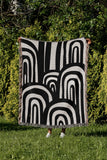 Lyno Abstract Print Cotton Throw Blanket in Black, outdoors