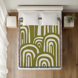 Lyno Abstract Print Cotton Throw Blanket in Chartreuse, on a bed