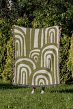 Lyno Abstract Print Cotton Throw Blanket in Chartreuse, outdoors
