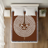 Mossi African Mask 100% Cotton Blanket in Rust Brown, on a bed