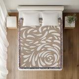 Nami Abstract Floral Blanket Throw in Beige, on a bed