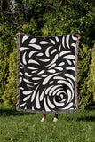 Nami Abstract Floral Blanket Throw in Black, outdoors