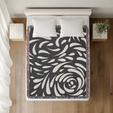 Nami Abstract Floral Blanket Throw in Gray, on a bed