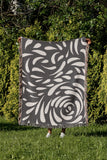 Nami Abstract Floral Blanket Throw in Gray, outdoors