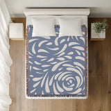Nami Abstract Floral Blanket Throw in Light Blue, on a bed