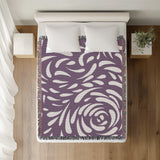 Nami Abstract Floral Blanket Throw in Purple, on a bed