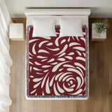Nami Abstract Floral Blanket Throw in Red, on a bed