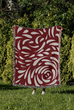 Nami Abstract Floral Blanket Throw in Red, outdoors
