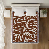 Nami Abstract Floral Blanket Throw in Rust Brown, on a bed
