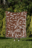 Nami Abstract Floral Blanket Throw in Rust Brown, outdoors