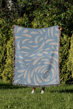 Nami Abstract Floral Blanket Throw in Sky Blue, outdoors