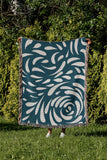 Nami Abstract Floral Blanket Throw in Teal, outdoors