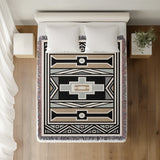 Ndebele Tribal Cotton Throw Blanket in Beige and Gray, on a bed