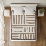Pereto Abstract Print Cotton Throw Blanket in Beige, on a bed