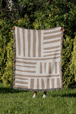 Pereto Abstract Print Cotton Throw Blanket in Beige, outdoors