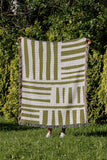 Pereto Abstract Print Cotton Throw Blanket in Chartreuse, outdoors