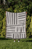 Pereto Abstract Print Cotton Throw Blanket in Gray, outdoors