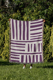 Pereto Abstract Print Cotton Throw Blanket in Purple, outdoors