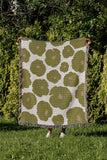 Poppi Floral Cotton Throw Blanket in Chartreuse, outdoors