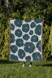 Poppi Floral Cotton Throw Blanket in Teal, outdoors