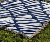 Pyro Abstract Print Cotton Throw Blanket in Blue, outdoors