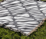 Pyro Abstract Print Cotton Throw Blanket in Gray, outdoors