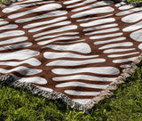 Pyro Abstract Print Cotton Throw Blanket in Rust Brown, outdoors