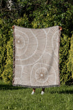 Ray Abstract Print Cotton Throw Blanket in Beige, outdoors
