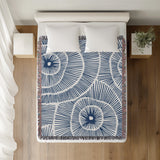 Ray Abstract Print Cotton Throw Blanket in Blue, on a bed