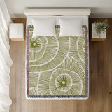 Ray Abstract Print Cotton Throw Blanket in Chartreuse, on a bed