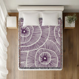 Ray Abstract Print Cotton Throw Blanket in Purple, on a bed