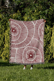 Ray Abstract Print Cotton Throw Blanket in Red, outdoors