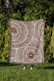 Ray Abstract Print Cotton Throw Blanket in Rust Brown, outdoors