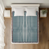 River Striped Cotton Throw Blanket in Teal, on a bed