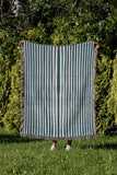 River Striped Cotton Throw Blanket in Teal, outdoors