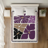Roni Floral Cotton Throw Blanket in Purple, on a bed
