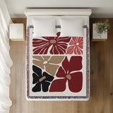 Roni Floral Cotton Throw Blanket in Red, on a bed