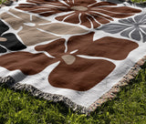 Roni Floral Cotton Throw Blanket in Rust Brown, outdoors