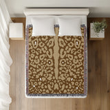 Sani Cheetah Print Cotton Throw Blanket in Beige and Brown, on a bed