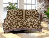 Sani Cheetah Print Cotton Throw Blanket in Beige and Brown, draped over a sofa