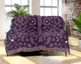Sani Cheetah Print Cotton Throw Blanket in Purple, draped over a sofa