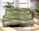 Sansevieria Leaf Cotton Throw Blanket in Green, draped over a sofa