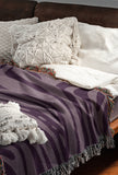 Sasha Zebra Print Cotton Throw Blanket in Lilac, draped over a sofa