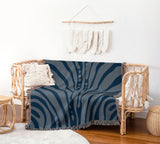 Sasha Zebra Print Cotton Throw Blanket in Navy Blue and Blue, draped over a sofa
