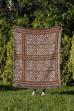 Thora Tribal Cotton Throw Blanket in Rust Brown, outdoors
