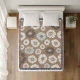 Valu Floral Cotton Throw Blanket in Beige, on a bed
