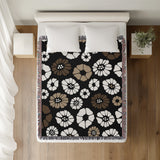 Valu Floral Cotton Throw Blanket in Black, on a bed
